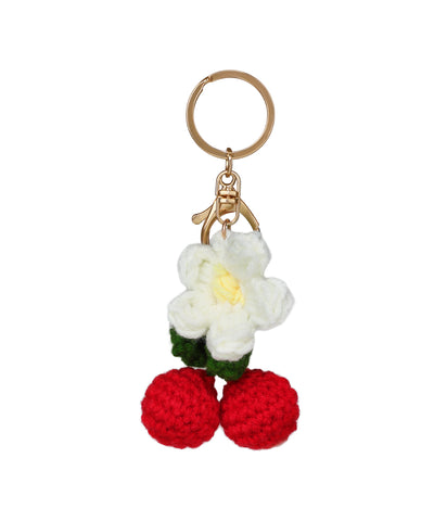 Gold-tone keychain with white crochet flower and red crochet cherry details