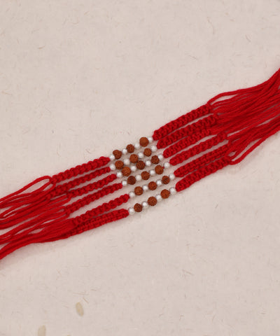Red multi-strand Rakhi with brown and silver-tone beads, tied with thread