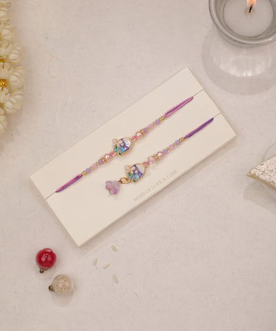 Gold-tone Rakhi set with enamel floral charms and purple & pink beads