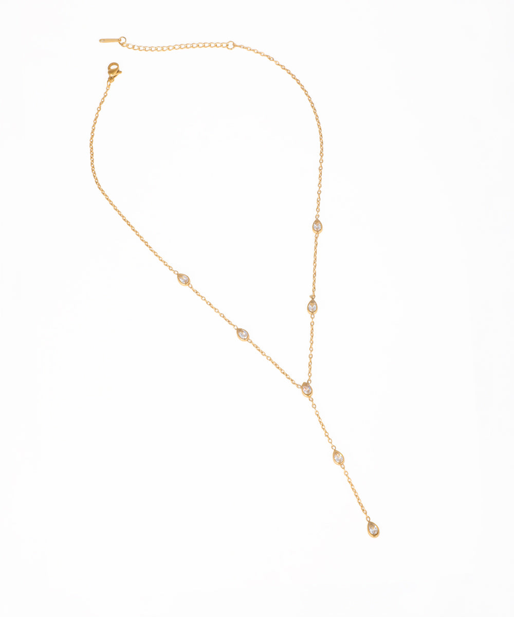 Gold-tone lariat necklace with multiple clear teardrop-shaped sparkling stone drops and a Y-chain design.
