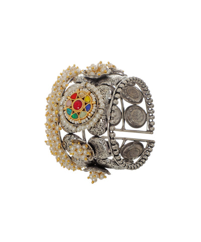 Oxidized silver-tone cuff bracelet with intricate floral design, multicolor stones, and faux pearl clusters.
