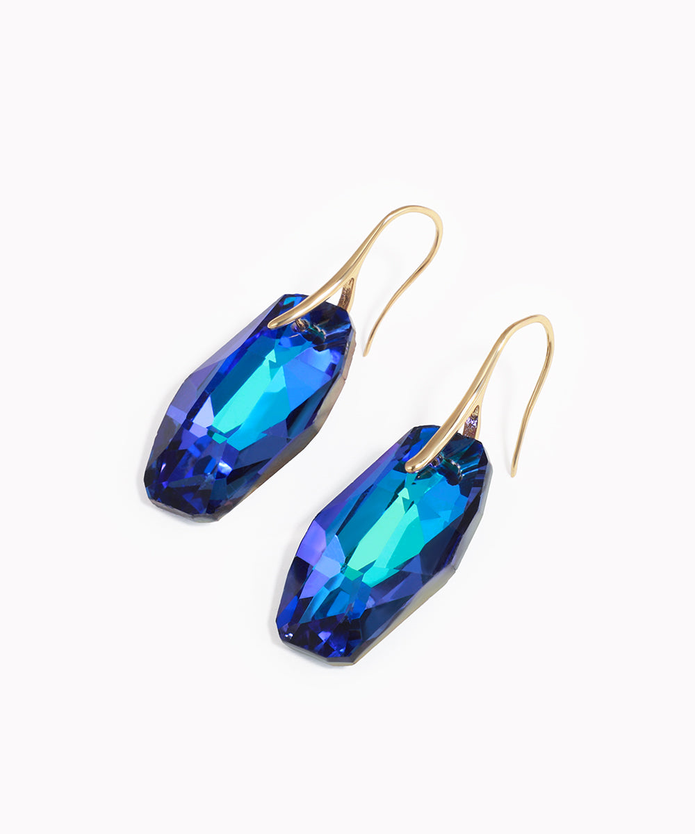 Gold-tone drop earrings with elongated blue and teal faceted glass crystals