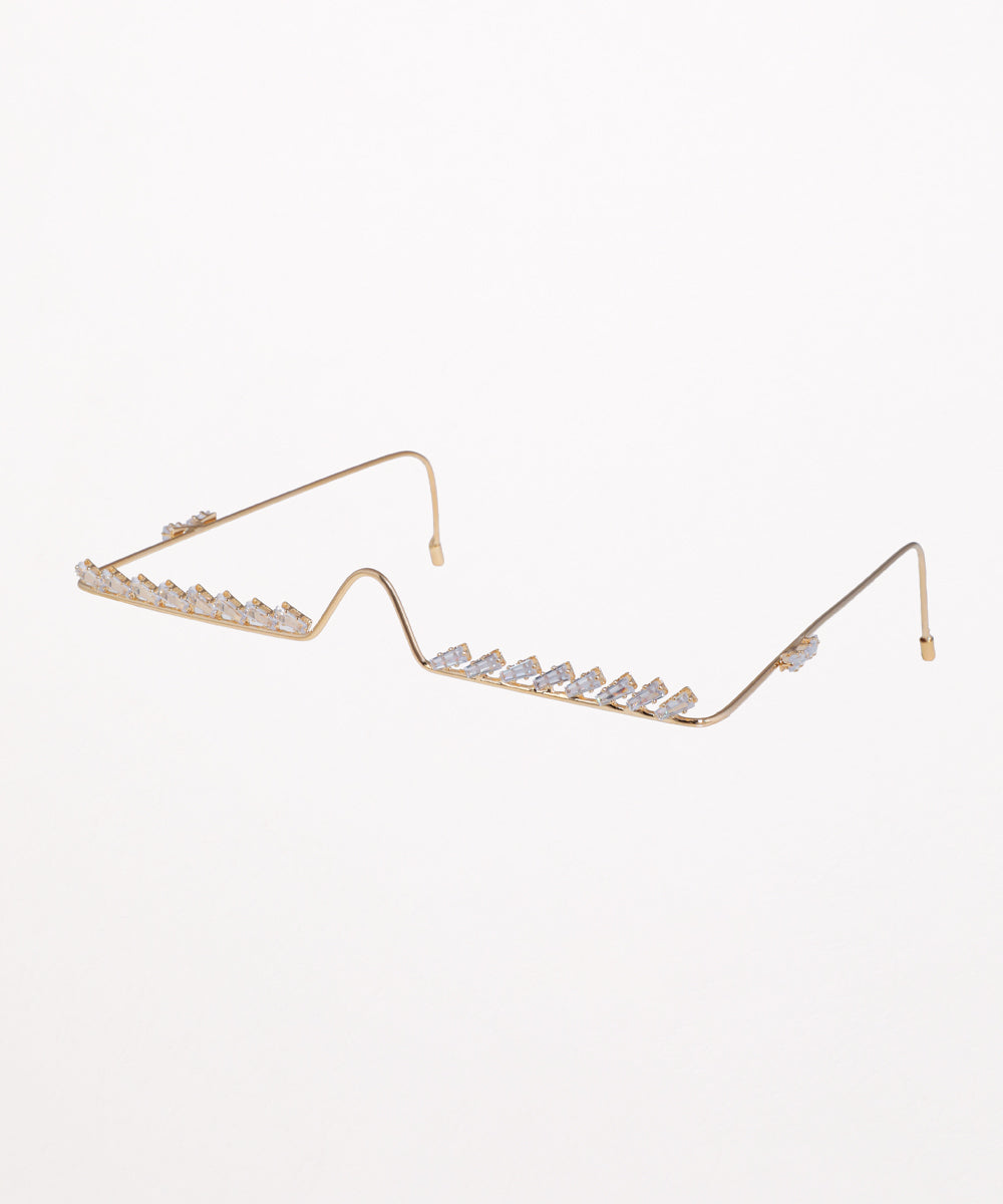 Gold-tone facelet with baguette-cut clear stones set along a delicate browline design, featuring ear hooks.