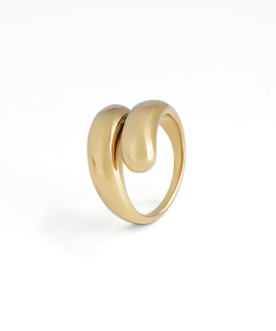 Polished gold-tone ring with a bold, fluid sculptural contour design