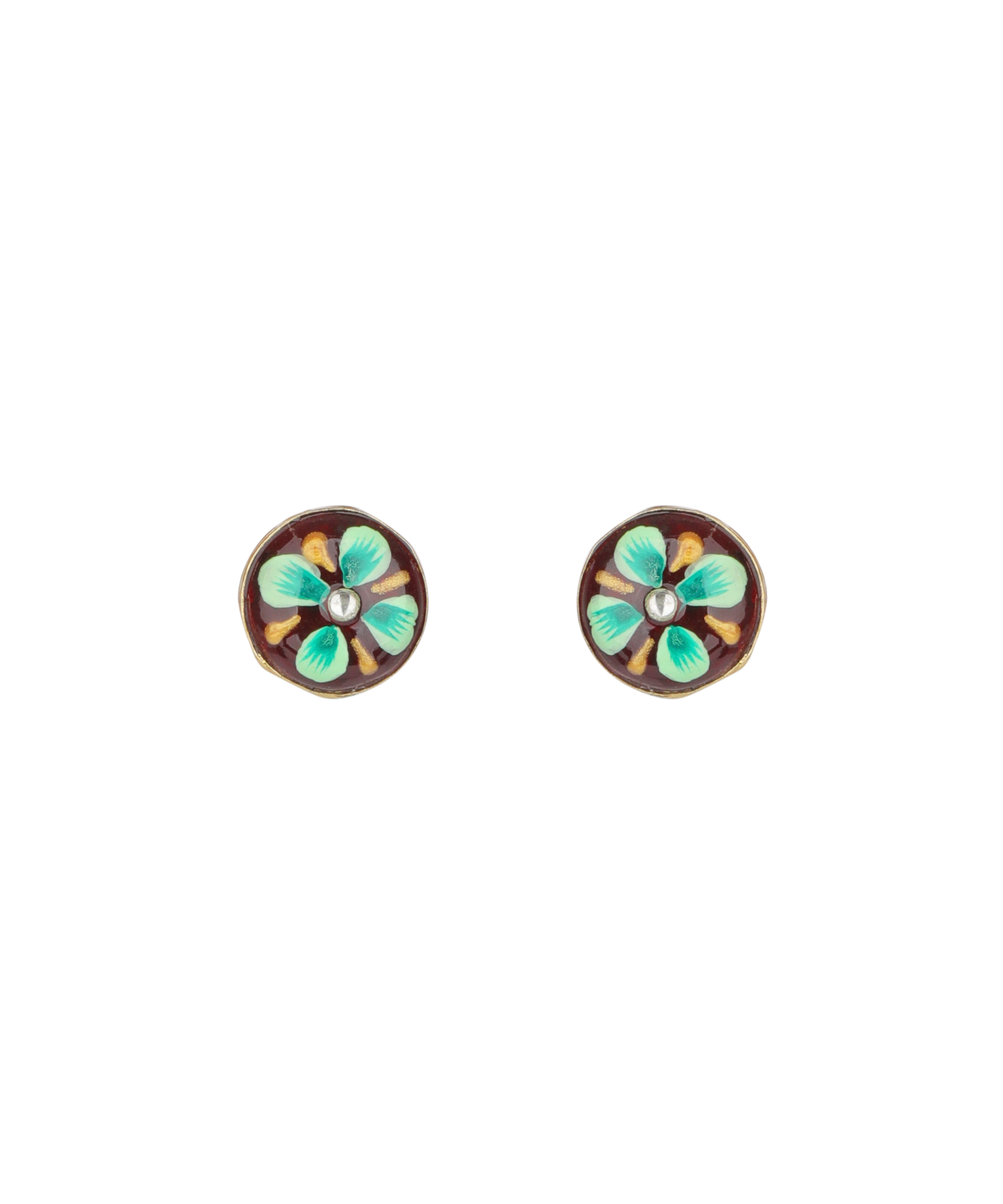 A pair of oval stud earrings with a vintage-style floral design. Each earring features a dark brown background with four light green and turquoise petals, a small white pearl-like center, and a gold-toned metal border.