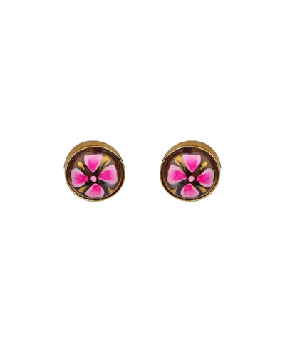 A pair of round gold-tone stud earrings featuring a pink and black floral design under a clear dome, shown on a plain white background.