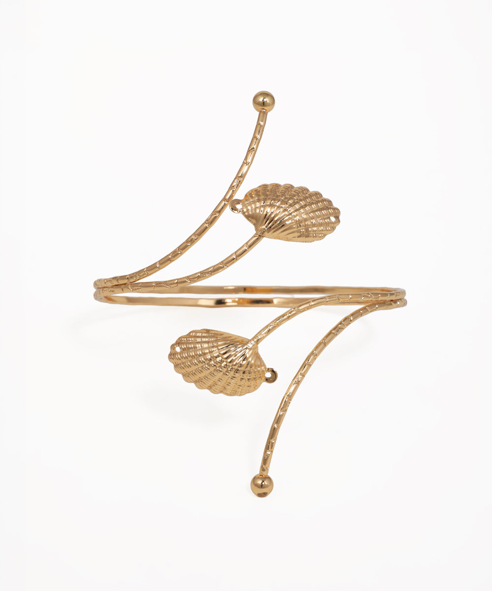 Gold-tone arm cuff with textured shell details and sculptural lines