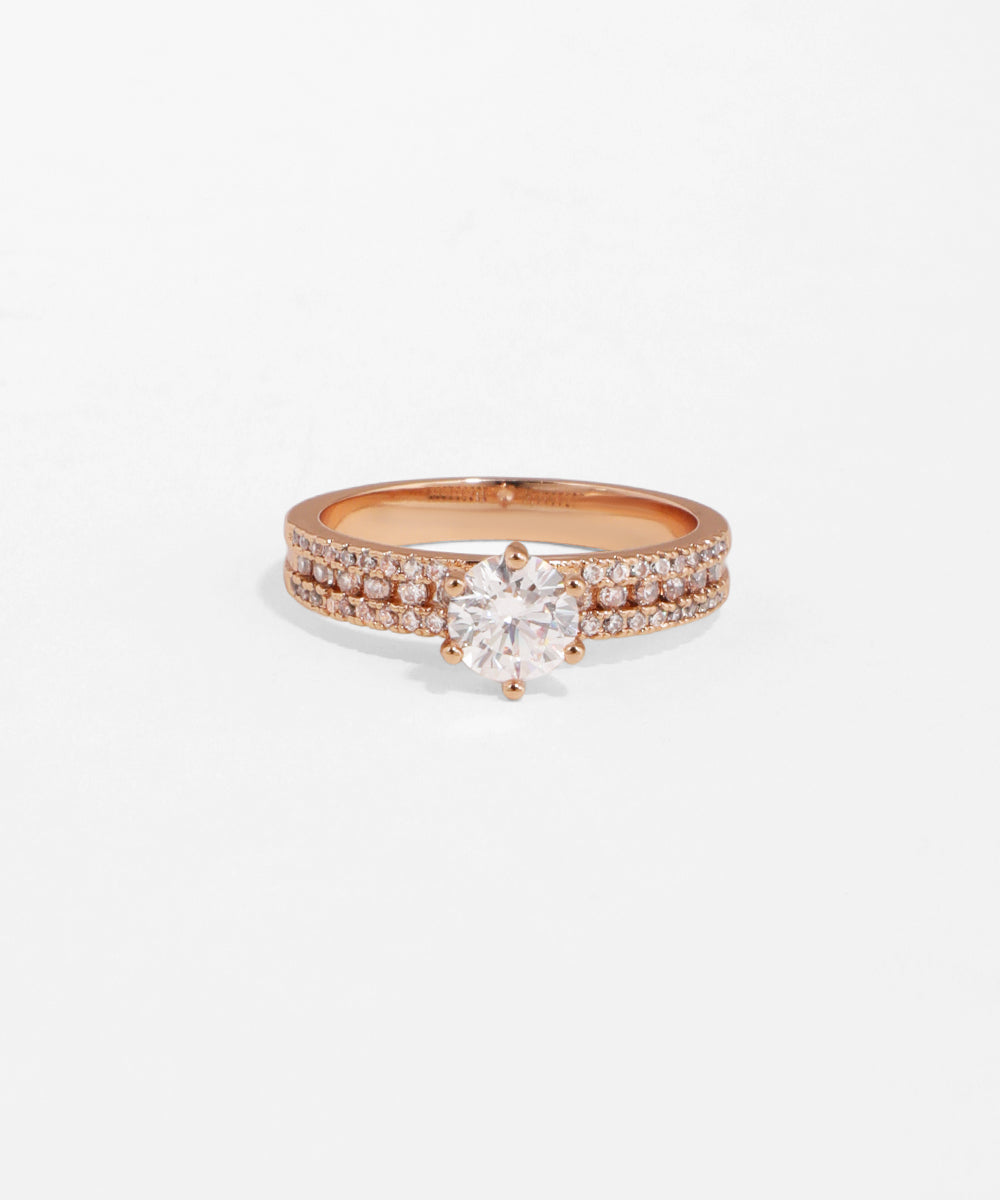 Rose gold ring with a diamond on a white background